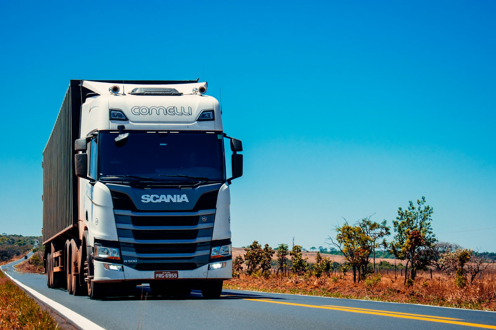 Freight truck on an open highway carrying a container