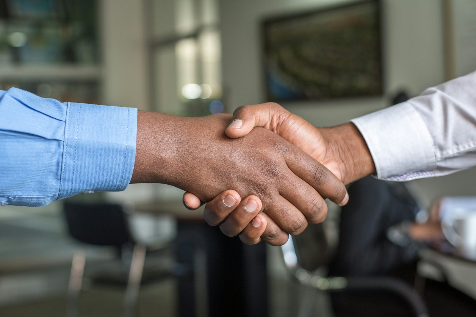 Two business partners shaking hands after agreeing a logistics contract