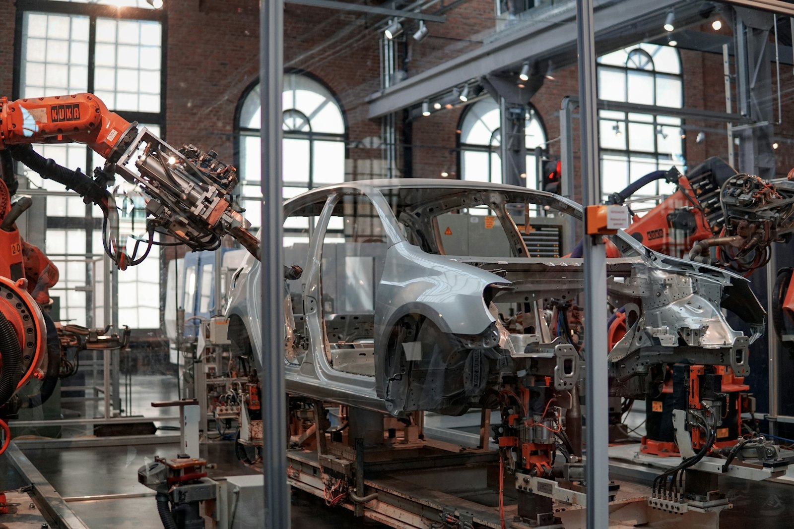Heavy industrial equipment being assembled and moved inside a facility
