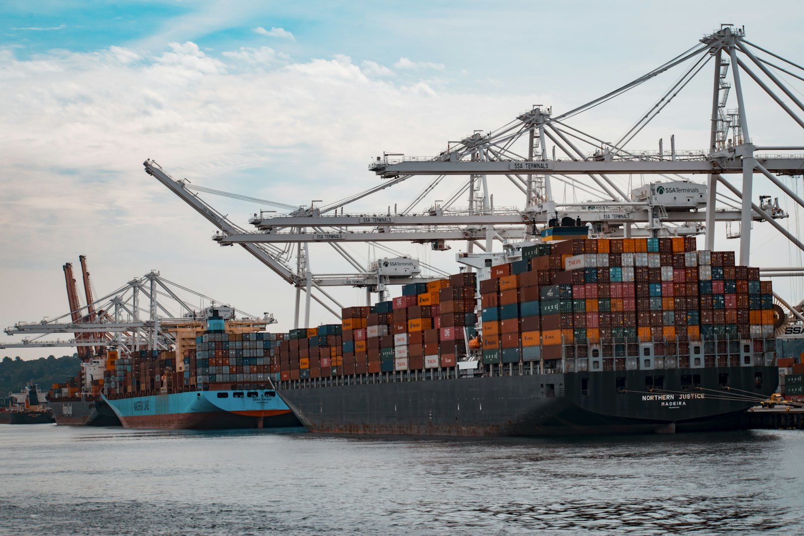 Container vessel being worked alongside a terminal berth